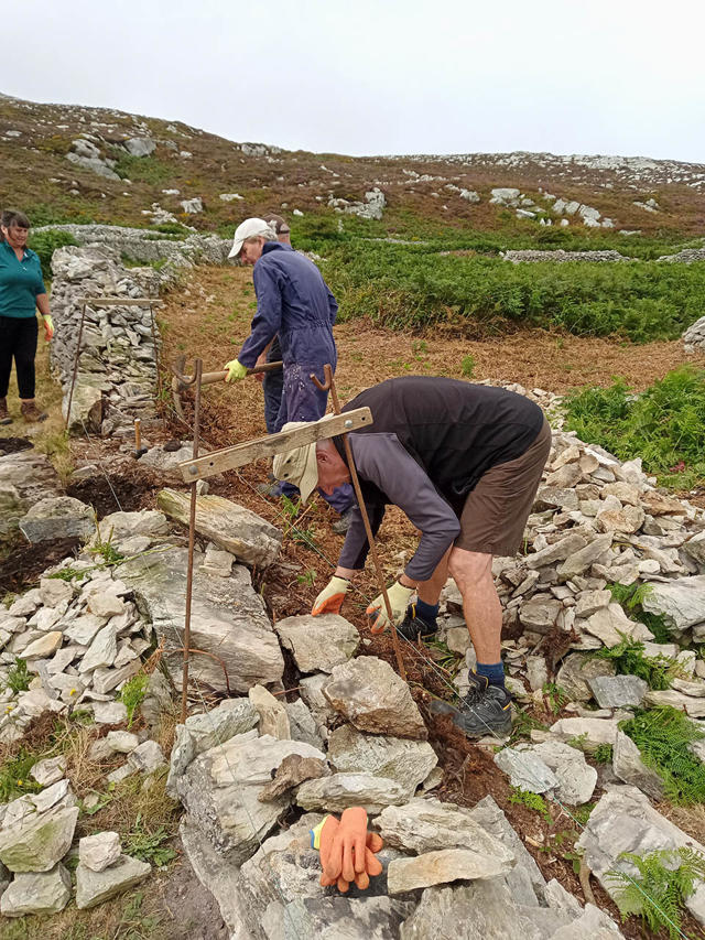 Volunteers laying the wall foundations before rebuilding