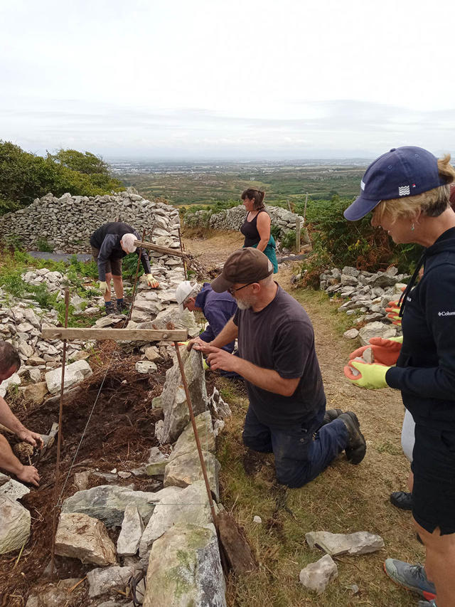 Trainer explaining drystone walling principles