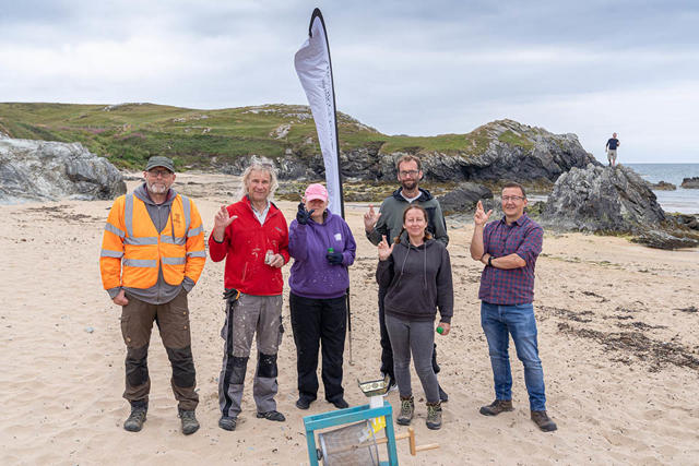Volunteers and staff at Porth Dafarch beach clean