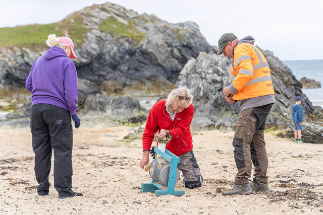 Volunteers using a nurdle catcher