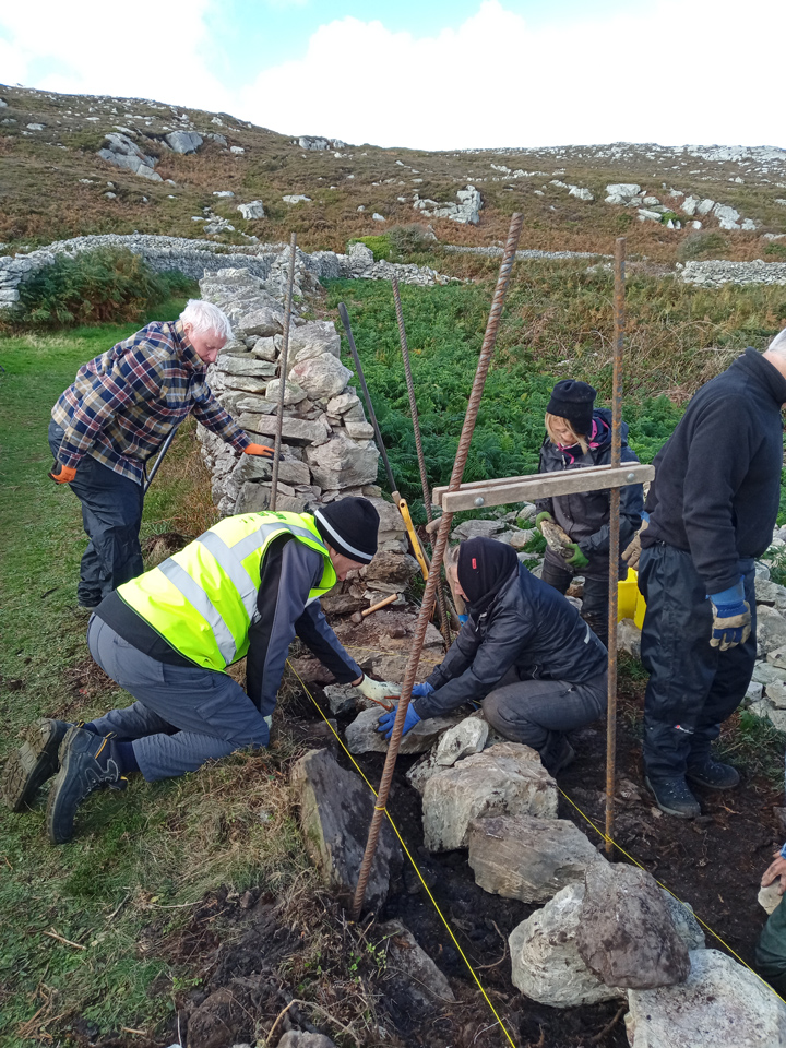 Volunteers placing foundation stones, Holyhead Mountain