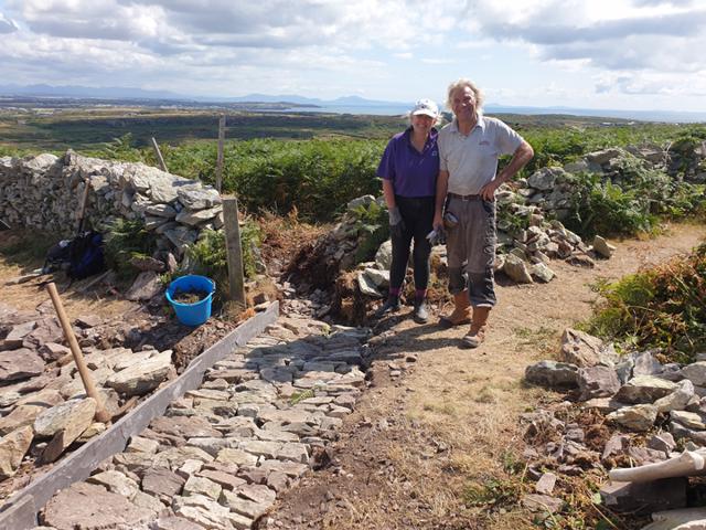 Volunteers with the stone work they completed