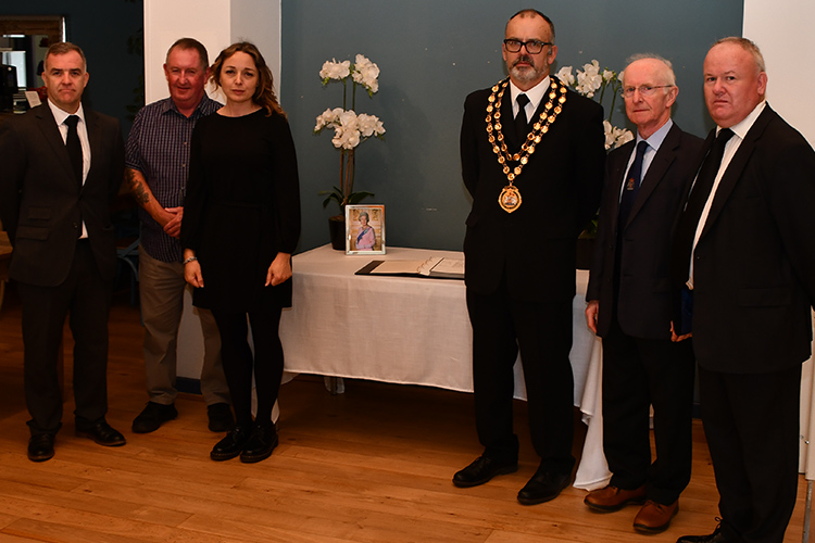 Council members and staff with the book of remembrance for HM Queen Elizabeth II
