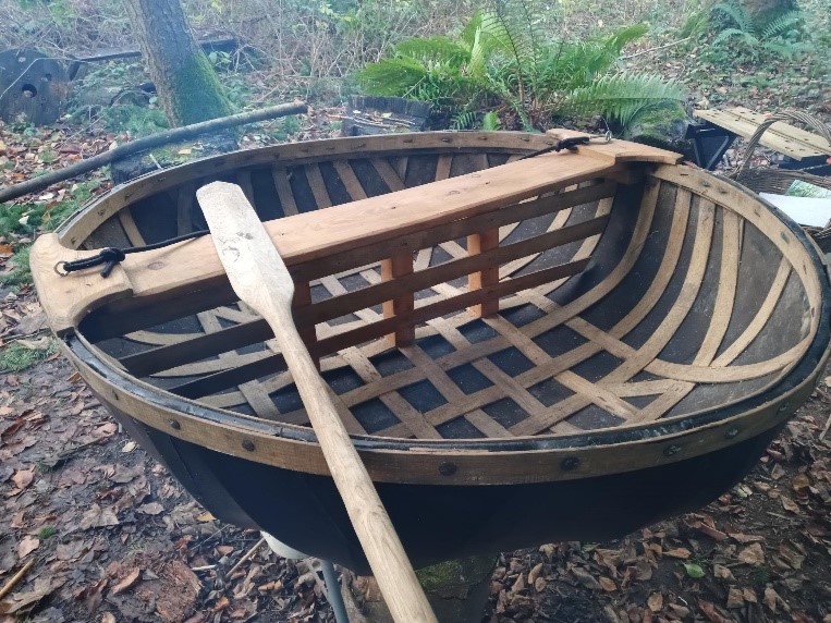A coracle being built