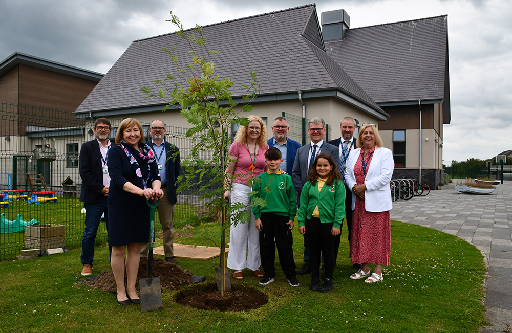 School children from Ysgol Santes Dwynwen planting a tree