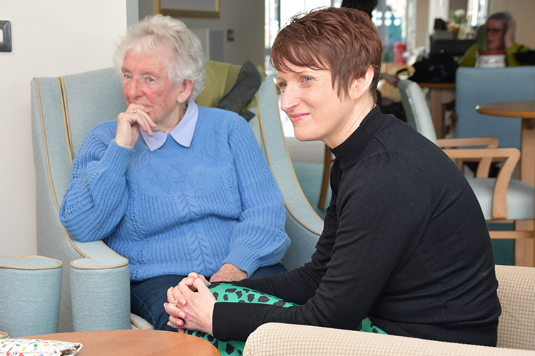 Two women sitting down.