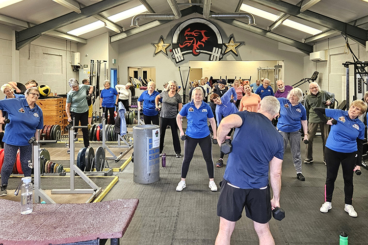 Group of people exercising in a gym.