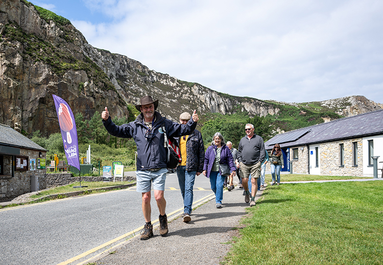 Group of people walking at Holyhead Breakwater Country Park.