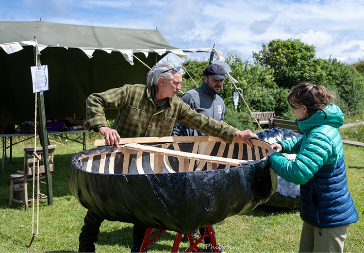 Group of people building a coracle.