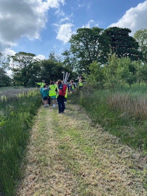 School children visiting a former landfill site at Penhesgyn to see the flourishing wildlife