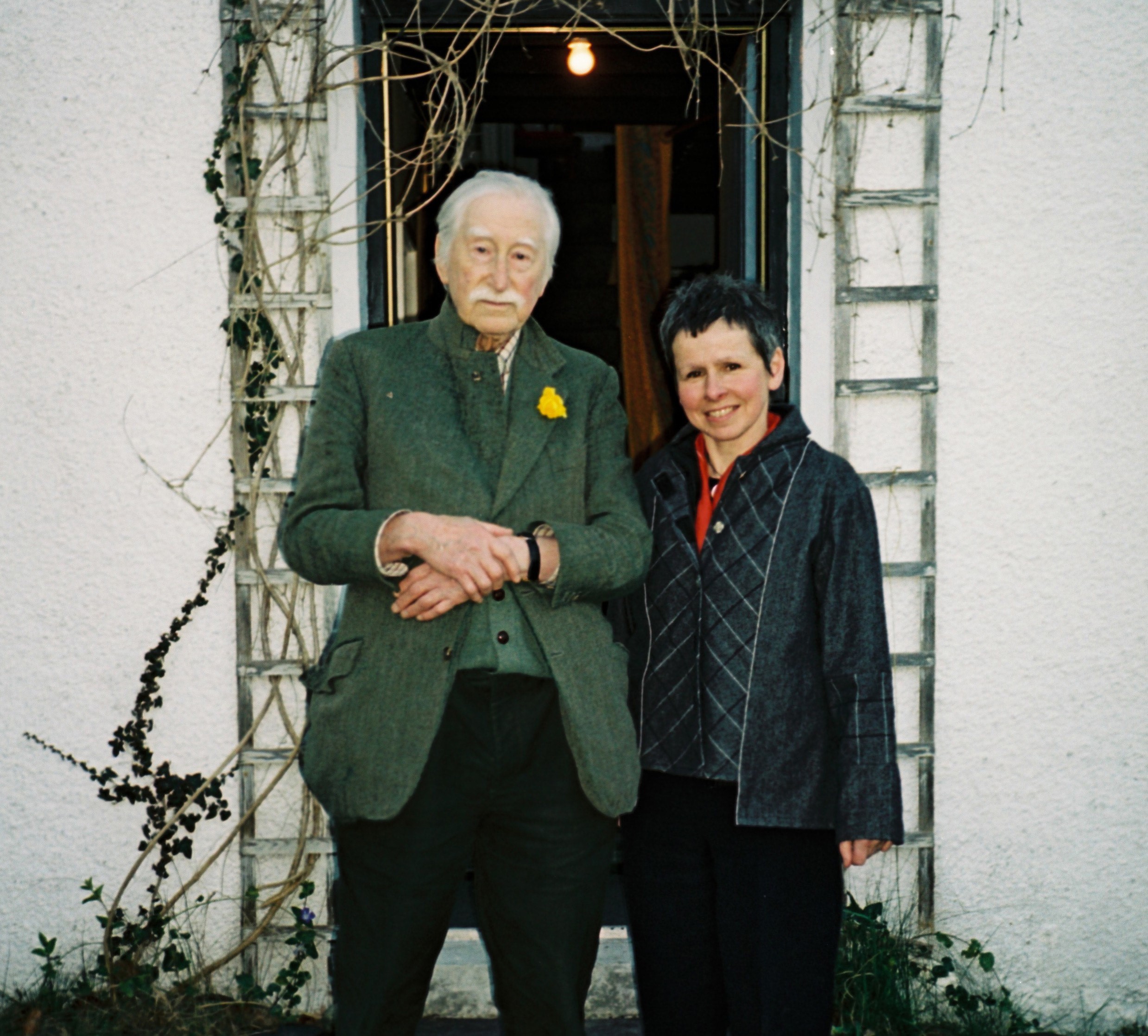 Artists Sir Kyffin Williams and Eleri Mills standing in a doorway