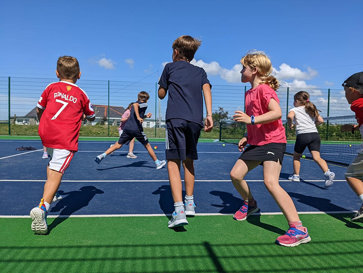 Young girls and boys playing sport in Rhosneigr