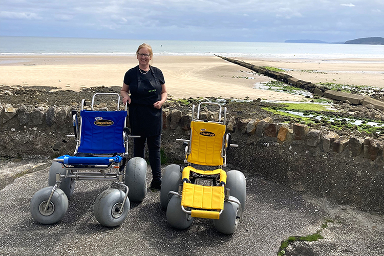 Two beach wheelchairs in front of Benllech Beach