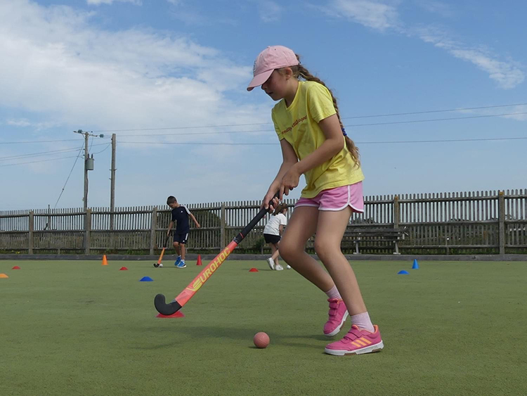 A young girl playing hockey.