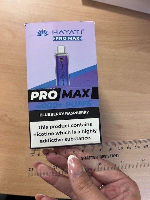 A vape box next to a ruler measuring around 8cm in width